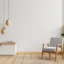 Living room interior wall mockup in warm tones,gray armchair with wood cabinet.3d rendering